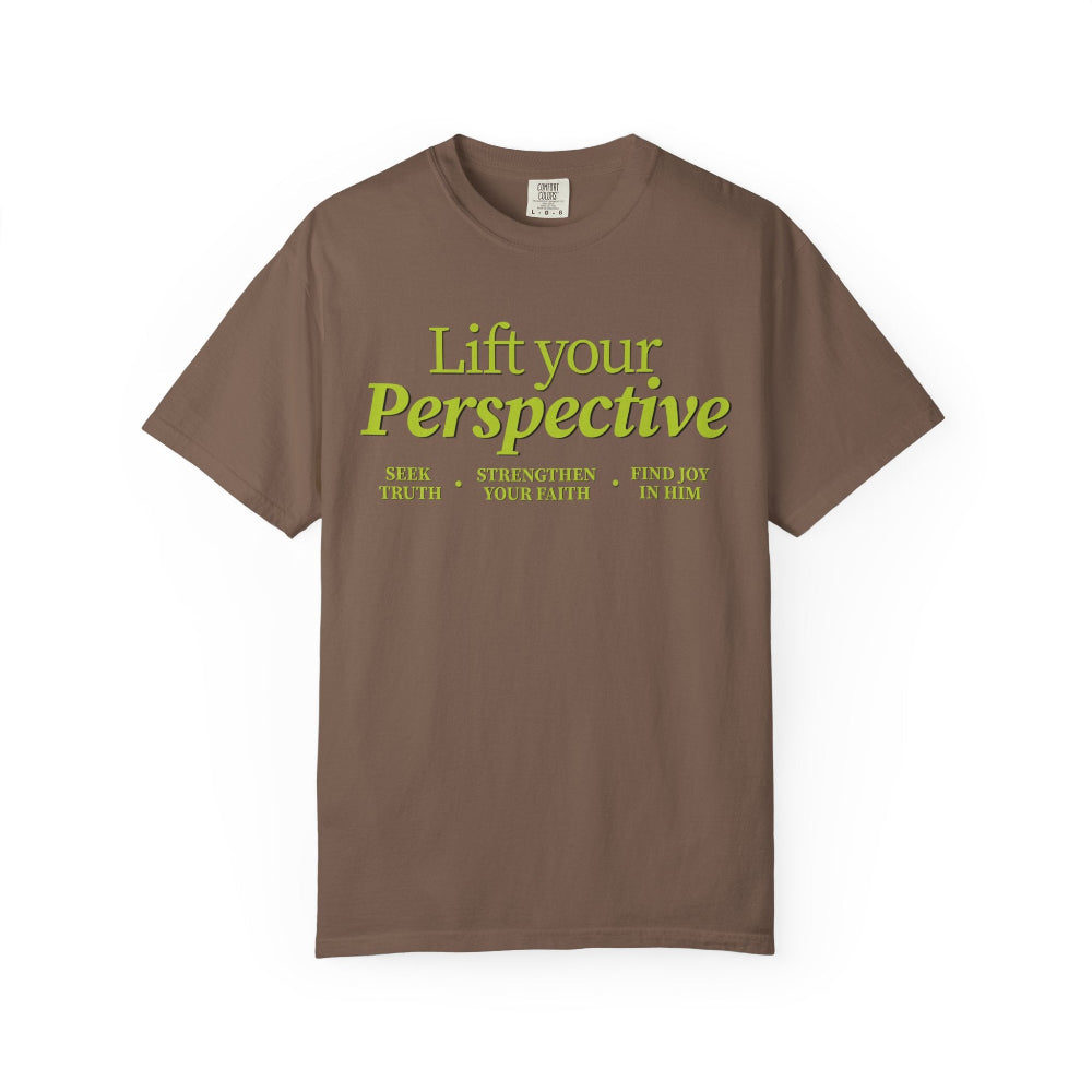 Young adult wearing “Lift Your Perspective” Christian T-shirt in brown, inspired by the How to Pray series.