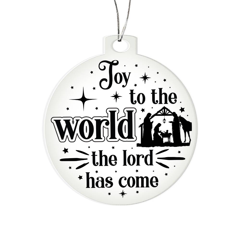 Clear Christmas ornament with nativity scene and "Joy to the World" text.