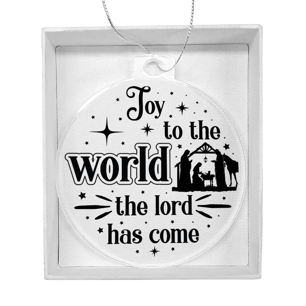 Clear Christmas ornament with nativity scene and "Joy to the World" text.