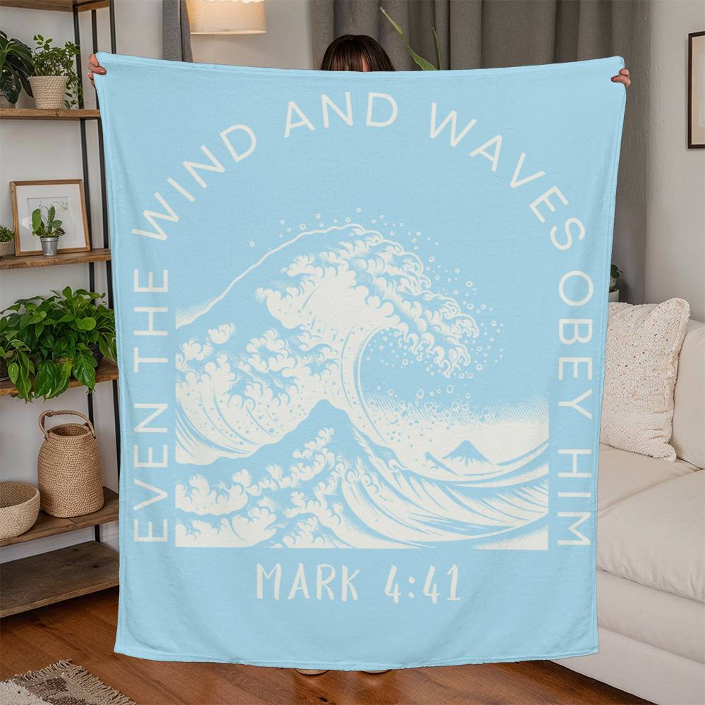 Light blue fleece blanket with white text, featuring 'Even the Wind & Waves Obey Him' with ocean wave design and Mark 4:41.