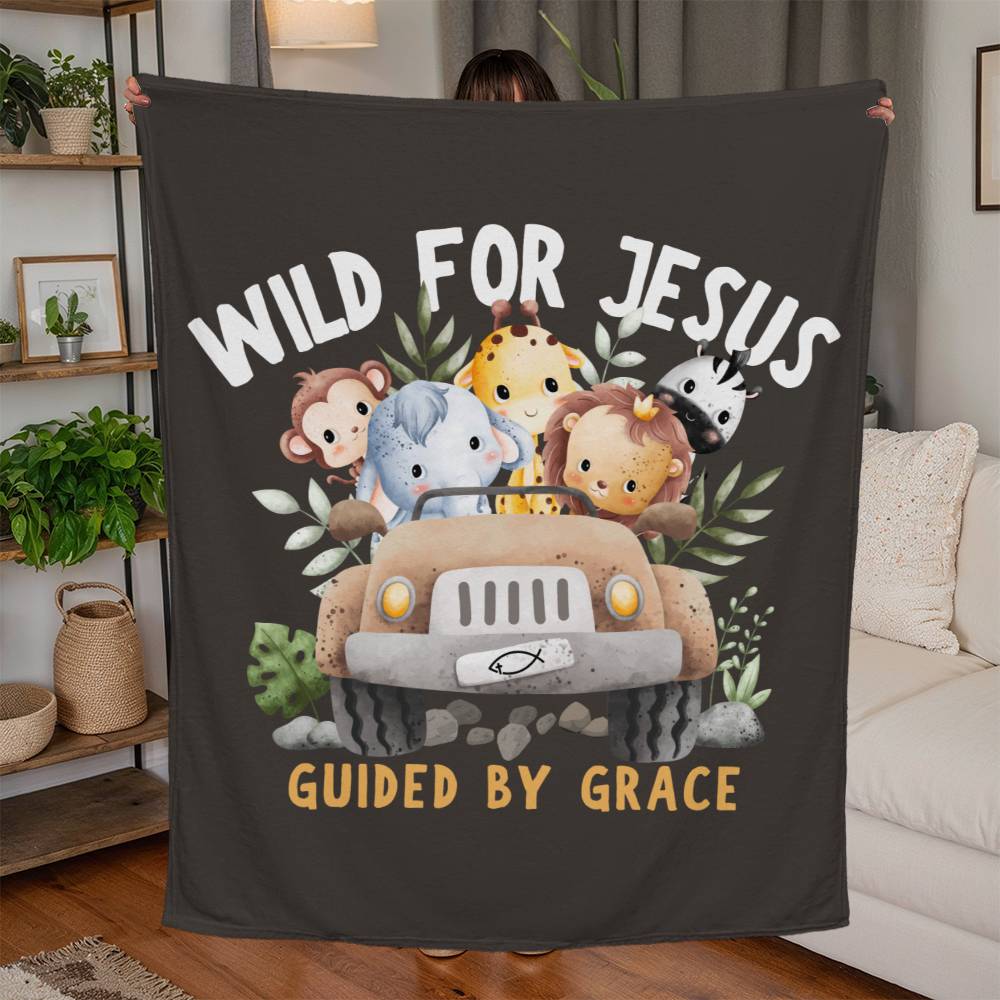 Dark brown blanket with jungle animals in a jeep, 'Wild for Jesus' text, and 'Guided by Grace' beneath in a playful design.