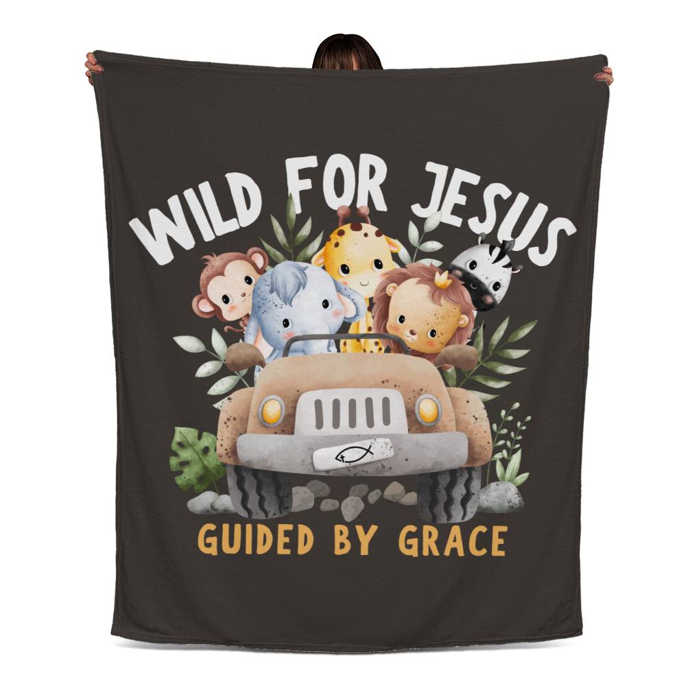 Dark brown blanket with jungle animals in a jeep, 'Wild for Jesus' text, and 'Guided by Grace' beneath in a playful design.