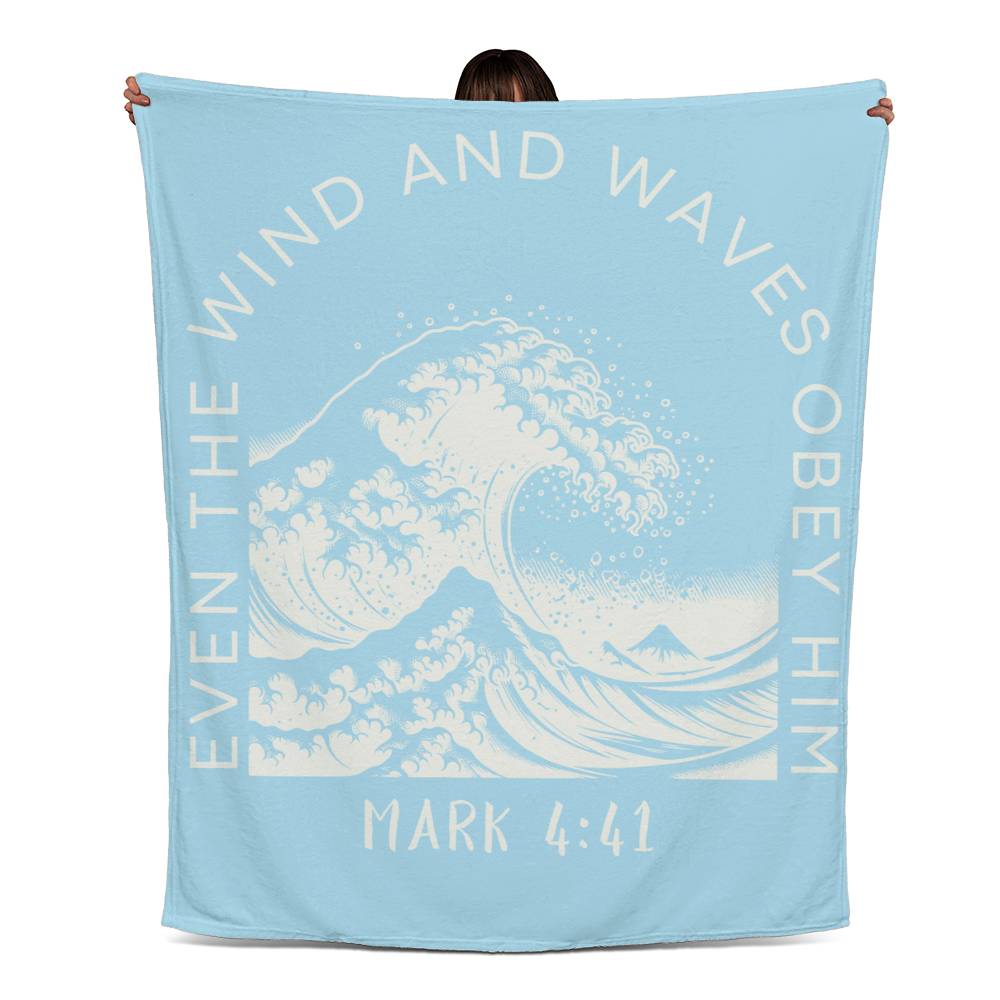 Light blue fleece blanket with white text, featuring 'Even the Wind & Waves Obey Him' with ocean wave design and Mark 4:41.