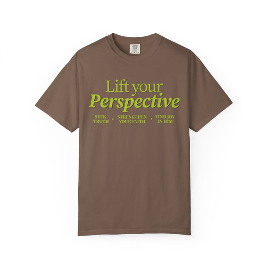 Young adult wearing “Lift Your Perspective” Christian T-shirt in brown, inspired by the How to Pray series.