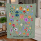 Floral fleece blanket with vibrant flowers, bugs, and 'Find Peace in God's Garden' message. Colorful and nature-inspired Christian blanket.
