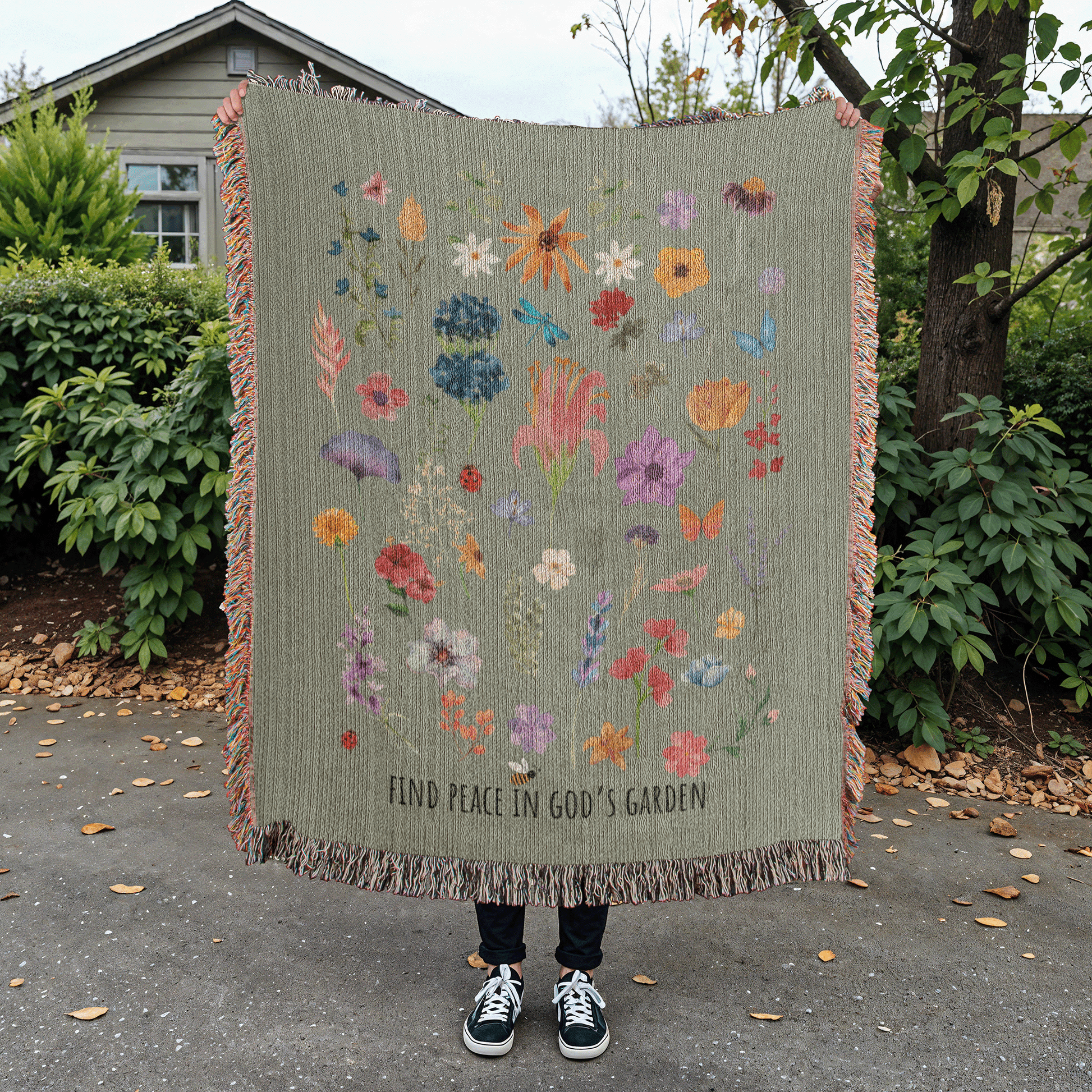 Floral woven blanket with vibrant flowers, bugs, and 'Find Peace in God's Garden' message. Colorful and nature-inspired Christian blanket.
